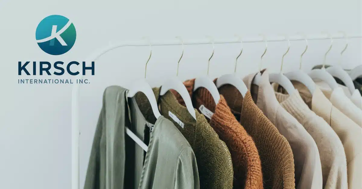Kirsch International logo beside a rack of apparel